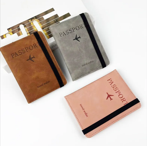 Passport covers in brown and gray with luggage tags